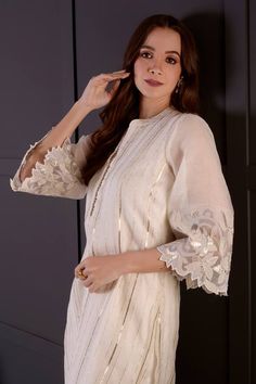 White mul chanderi short kurta with cutwork, zari and gota embroidery. Comes with modal satin dhoti pant. - Aza Fashions Elegant Cutdana Salwar Kameez For Eid, Elegant Straight Kurta Set With Cutdana, Elegant Salwar Kameez With Cutdana For Eid, Elegant Navratri Sets With Gota Work, Elegant Cutdana Kurta For Festivals, Elegant Cutdana Sharara For Eid, Elegant Kurta With Cutdana For Festivals, Elegant Semi-stitched Kurta With Cutdana, Elegant Sharara With Straight Kurta For Navratri