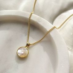 *45cm 18k gold filled brass chain *18k gold plated pendant with mother of pearl style shell accents *Gold filled lobster clasp closure Handmade in Sydney, please allow up to 3 business days for production. Gold Mother Of Pearl Necklace With Pearl Chain, Gold Pearl Necklace With Pearl Charm, Gold Pearl Necklace With Mother Of Pearl Charm, Dainty Gold Mother Of Pearl Necklace, Gold Shell Necklace Made Of Mother Of Pearl, Gold Pendant Pearl Necklace With Mother Of Pearl, Gold Mother Of Pearl Pendant Necklace, Elegant Gold Round Shell Necklace, Gold Mother Of Pearl Necklace For Gift