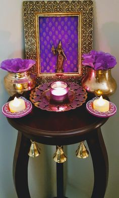 an ornate table with candles and pictures on it