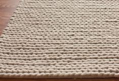 a white rug on top of a wooden floor