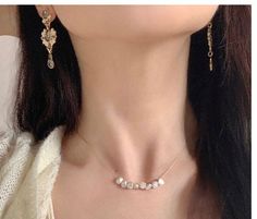 Woman wearing a dainty baroque pearl necklace, complementing her elegant attire. Pearl Necklace Real, Delicate Gold Chain, Real Pearl Necklace, Understated Luxury, Baroque Pearl Necklace, Freshwater Pearl Necklace, Freshwater Pearl Necklaces, Simple Earrings, Gold Filled Chain