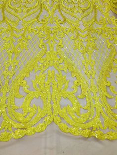 yellow sequin lace fabric on white background