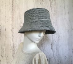 Crocheted grey raffia hat It is a classic accessory for sun protection, summer parties, beach and travel. The hat is crocheted from natural raffia, light, elastic, small fields of the hat are reinforced with wire. The hat keeps its shape well and does not fade in the sun. The cap is soft to the touch, slightly rough. It is fully crocheted. Easy to carry with foldable design. The hat is perfect for summer wardrobe. Field Size: about 2,7 inches (7 cm) Care of the product:        It is better to dry the hat naturally, without using additional heating sources. When the raffia product dries, it returns to its original shape.        You cannot wash them in the usual way. If it gets dirty, clean it with soapy water and a sponge. The surface is gently wiped and left to dry in the shade. Items shou Gray Beach Hat For Spring, Gray Spring Vacation Hat, Lightweight Gray Sun Hat For Summer, Gray Lightweight Sun Hat For Summer, Gray Brimmed Bucket Hat For Beach, Gray Brimmed Bucket Hat For Summer, Adjustable Wide Brim Gray Bucket Hat, Gray Lightweight Summer Sun Hat, Gray Curved Brim Bucket Hat For Summer