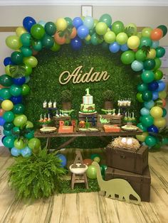 an outdoor birthday party with balloons and decorations