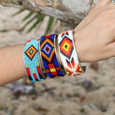 A metallic cuff with a beaded design in brilliant colors calling out a true southwest feel. Band is 2 3/8 inches in diameter, Cuff is approximately 1 inch wide. Land Of Enchantment, Black Orange, Brilliant Colors, Orange Black, Cuff Bracelet, Embroidered Friendship Bracelet, 1 Inch, White And Black, Cuff