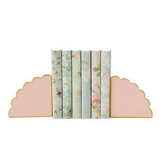 four bookends with flowers on them are lined up next to each other in front of a white background