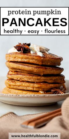 a stack of pancakes topped with whipped cream and cinnamon