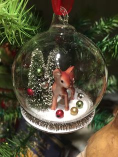 a glass ornament hanging from a christmas tree