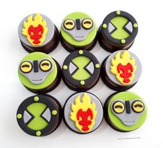 six decorated cookies with different designs on them are arranged in the shape of an alien face