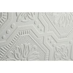 close up view of the white textured wallpaper with an intricate design on it