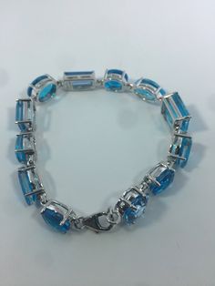 This Blue Topaz and Blue Quartz bracelet is very lively and bright. The stones are deep colors and different tones of blue The sterling silver is plated with rhodium to protect the bracelet from tarnish and give the appearance of white gold. 8 inches All jewelry is shipped in a nice gift box. Check out our over a THOUSAND great reviews Engraving is $4 per letter and is not always perfect depending on the piece. It can take a few days if the jeweler is busy. This is payable to Paypal Judithsltd@g Formal Blue Topaz Blue Bracelets, Formal Blue Topaz Bracelets, Luxury Blue Gemstone Sterling Silver Bracelet, Modern Blue Gemstone Bracelets, Modern Blue Gemstone Bracelet, Modern Blue Faceted Jewelry, Blue Sterling Silver Bracelet For Formal Occasions, Fine Jewelry Blue Sterling Silver Bracelet As Gift, Blue Gemstone Bracelets In Fine Jewelry Style