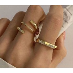 This Is A Set Of Two Gold-Tone Rings. The First Ring Is A Simple Band With A Row Of Clear Cubic Zirconia Stones. The Second Ring Is A More Intricate Design With A Twisted Band. Both Rings Are In New Condition With Tags And Are Made Of Metal. The Rings Are Approximately 1 Inch In Diameter. The Rings Are Perfect For Adding A Touch Of Sparkle To Any Outfit. Sterling Silver Promise Rings, Simulated Diamond Rings, Bar Ring, Rhinestone Ring, Diamond Bar, Silver Band Ring, One Ring, Blue Topaz Ring, Open Ring