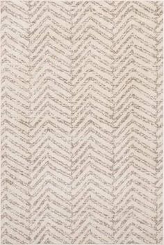 an area rug with white and grey chevrons