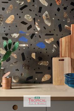 a kitchen counter topped with lots of different types of utensils and plates on top of it