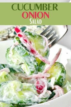 cucumber onion salad in a white bowl with a red and green striped fork