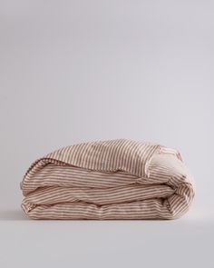 the linens are folded on top of each other, and one is brown and white