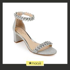 a pair of silver high heeled shoes with crystal embellishments on the ankle