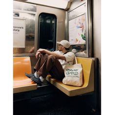 a man sitting on a subway train seat