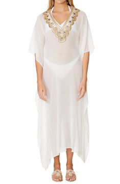 Enjoy sunny days in this elegant cover-up caftan crafted in a semisheer silhouette with striking beadwork. V-neck Three-quarter sleeves 100% viscose Dry clean Imported Model stats: 5'10" height, 32" bust, 25" waist, 36" hip. Model is wearing size One Size. Bohemian Sheer Kaftan For Beach, Elegant Short Sleeve Kaftan For Summer, Elegant Short Sleeve Kaftan For Vacation, Elegant Embroidered Neckline Tunic For Summer, Elegant Summer Tunic With Embroidered Neckline, Elegant Short Sleeve Tunic For The Beach, Elegant Short Sleeve Beach Tunic, Sheer Kaftan For Summer Vacation, Embellished Tunic Kaftan For Vacation