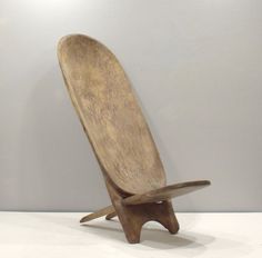 a wooden chair sitting on top of a white table