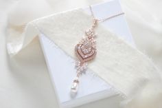 "This lovely necklace I created using a fabulous Rose Gold plated cubic zirconium component that is so full of sparkle and features tons of cz stones in different shapes and sizes. I finished it with a Swarovski pearl drop. Necklace measures 16 inches and extends to 18 inches with an extension chain and has a lobster clasp closure. CZ pendant measures 3-3/8\" x 1\". PLEASE ALLOW APPROX 7 BUSINESS DAYS FOR COMPLETION BEFORE SHIPPING ** If you do not want any pearls please choose crystal drop from Bridal Pendant Necklace, Gold Bridesmaid Necklace, Rose Gold Bridesmaid, Bridal Pendant, Gold Bridal Necklace, Rose Gold Pendant Necklace, Backdrops Necklace, Gold Bridesmaids, Pearl Drop Necklace