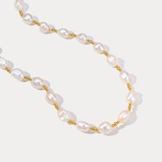 Experience the epitome of elegance with our Golden Baroque Pearl Necklace. This exquisite necklace features uniquely shaped baroque pearls, each one distinct with its own irregular and organic form, creating a one-of-a-kind masterpiece. The pearls are interspersed with delicate golden beads, adding a touch of opulence and sophistication to the design. This necklace is more than just an accessory; it is a statement of elegance and timeless beauty. DETAILS Plating: 18K Gold Materials: 18K Gold on Gold Baroque Pearl Bracelet With Pendant, Gold Baroque Pearl Necklaces, Gold Baroque Pearl Charm Necklace, Gold Baroque Pearl Necklace With Pearl Charm, Gold Pearl Necklace With Baroque Pearls, Gold Baroque Necklace With Pearl Charm, Classic Gold Necklace With Baroque Pearls, Gold Baroque Pearl Necklace, Elegant Gold Beaded Baroque Pearl Necklaces