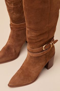 All your most exceptionally stylish fall looks are definitely going to include the Dolce Vita Tyrone Wide Calf Brown Suede Buckle Pointed-Toe Knee-High Boots! These genuine suede leather boots have a chic pointed-toe upper that rises to a 14"" knee-high with a 16.75"" circumference, an elastic gusset at the instep, and a curved topline. 8.5"" zipper at the instep. An adjustable buckle strap wraps around the ankle for a unique finishing touch! 3. 25" stacked block heel. Lightly cushioned insole. Rubber sole has nonskid markings. Genuine Suede Leather Upper. Man Made Materials. Imported. Lulus | Tyrone Wide Calf Brown Suede Buckle Pointed-Toe Knee-High High Heel Boots | Size 9.5WC. Suede Leather Boots, Wide Calf, Heel Boots, Fall Looks, High Heel Boots, Suede Boots, Brown Suede, High Boots, Knee High Boots