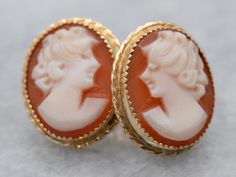 "These cameo studs are simply charming! Classic bezel settings of 14 karat gold are accented by beaded edging that catches the light beautifully. These demure ladies have flowing curls in their hair that emphasizes the feminine style of these earrings. Metal: 14K Yellow Gold Gem: Shell Cameo Gem Measurements: 12.2 x 9.9 mm, Oval Earrings Length: 14 mm Earrings Width: 12 mm Marks: \"14K\" Stamped on the Findings SKU #: A15755 Each piece has been identified and graded by a Graduate Gemologist cert Elegant Cameo Earrings, Elegant Round Cameo Earrings, Elegant Cameo Clip-on Earrings Gift, Heirloom Style Earrings For Formal Occasions, Classic Cameo Earrings For Wedding, Formal Screw Back Earrings, Elegant Cameo Earrings For Wedding, Wedding Jewelry With Screw Back, Beaded Edging