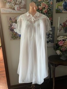 Offered is a vintage peignoir set, nightgown and matching robe from Seamprufe. Snow White in color it's the perfect bridal/anniversary set. Lots of lace. Both pieces are double chiffon. Sheer and see through.  The gown has a pleated skirt and lace straps.  Robe closes with 2 neckline buttons and a tie.  Tagged as size 34 and shown on my size 34 mannequin. Busy measures 36" Under bust 29" Hips are full Length shoulder to hem 40" Condition is excellent. This was someone's special set worn very lit