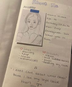 an open notebook with a drawing of a woman's face and words on it