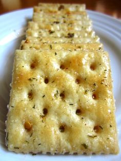 three crackers on a white plate sitting on a table