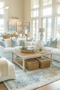 a living room filled with lots of white furniture and pillows on top of a rug