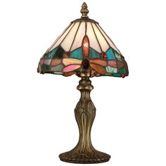 a lamp that is sitting on top of a table with a glass shade over it