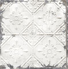 an old white tin ceiling tile with fleur de lis on the top and bottom