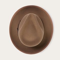 An icon of the Stetson brand, the Whippet Fedora epitomizes the sophisticated style of the American post-war era with its timeless, versatile profile and a brim that can look casual and cool when snapped up, or snapped down for a dressed-up and dapper look. Handcrafted with a firm finish from high-quality 100% wool felt and richly dyed in versatile shades, the Whippet features a slightly tapered 4 ½" pinch front teardrop crown and a 2 ⅜” bound edge brim. Its classic style is underscored by a gro Modern Cowboy, Wool Fedora Hat, Wool Fedora, Casual Bottoms, Denim Boots, Black Camel, Thigh Boot, Cool Hats, Whippet