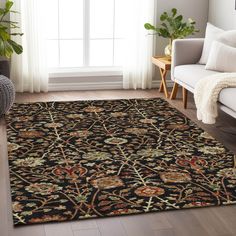 a living room area with a couch, chair and rug on the floor in front of a window