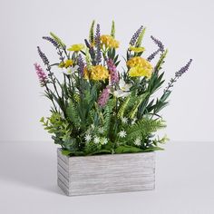 an arrangement of flowers in a vase on a table