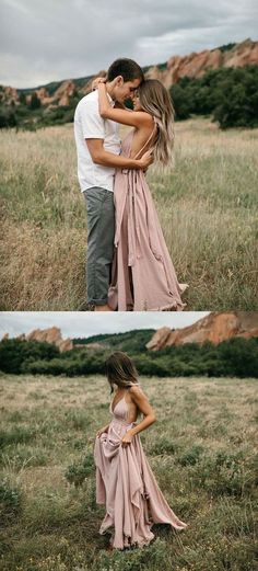 a man and woman are hugging in the field