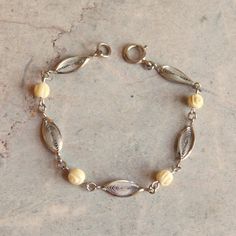 "Vintage mid-century 12K Gold Filled bracelet features 4 carved rose bone beads interspersed with twisted-leaf links that look like cannetille (spun silver. This delicate bracelet would make a nice gift for a young girl but it fits an adult as well. Size: 7-1/4\" long Age: Mid-century era (estimated) Materials: 12K gold filled base metal, bovine bone Fastener: Spring-ring clasp Marks: \"1/20 12K GF\" on clasp Condition: Excellent pre-owned condition.   SHIPPING INFO: This item ships for free to the United States. I use Calculated Shipping for international orders. Etsy will automatically combine shipping if you have more than one item in your cart from the same seller. If I can ship for less than you paid, I will refund the difference (if it is over $2).  INTERNATIONAL BUYERS: Please under Bone Horn, Carved Bone, Bone Beads, Bone Carving, Bracelet Vintage, Cool Vintage, Cool Necklaces, Go Green, Bead Bracelet