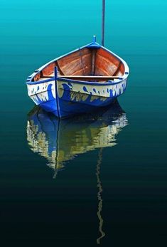 a small boat floating on top of a body of water