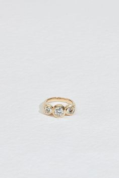 a gold ring with three diamonds on it