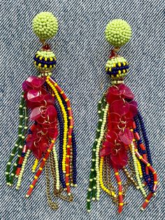 The art of beadwork has been practiced since the 16th Century. These lively beaded earrings are a modern take on the traditional craft. At once delicate and dramatic, these long chandelier earrings are light weight and eminently wearable. "Cha Cha Real Smooth" tassel earrings, 5" long Traditional Green Beaded Earrings For Party, Traditional Green Beaded Party Earrings, Traditional Beaded Fringe Chandelier Earrings, Traditional Multicolor Beaded Earrings For Party, Traditional Multicolor Beaded Party Earrings, Bohemian Earrings With Colorful Beads For Celebration, Red Beaded Drop Earrings With Latkans, Festive Multicolor Beaded Earrings With Latkans, Bohemian Chandelier Earrings With Colorful Beads