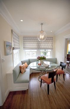 a living room filled with furniture and a glass top table in front of a window