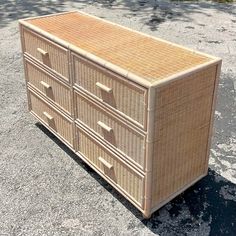 a wicker dresser sitting on top of a parking lot