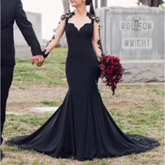 a man and woman holding hands in front of a grave