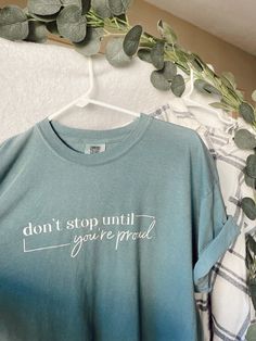 Don't Stop Until You're Proud | Comfort Colors Tee Shirt * Comfort Colors brand * Color of shirt: Ice Blue * 100% cotton, extremely soft * Made with premium white vinyl  * Unisex Sizes S-3X Casual Crew Neck Top With Quote Print, Casual Short Sleeve Tops With Quote Print, Trendy Relaxed Fit Top With Quote Print, Casual Crew Neck Shirt With Quote Print, Inspirational Screen Print Crew Neck Top, Relaxed Fit Crew Neck Top With Quote Print, Crew Neck Cotton Shirt With Quote Print, Inspirational Cotton Tops With Text Print, Cotton Crew Neck Shirt With Quote Print