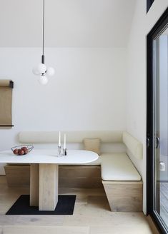 a white table and bench in a room