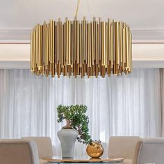 a dining room table with chairs and a chandelier hanging from the ceiling over it