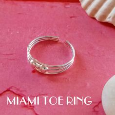 "925 Sterling Silver ring open at the back ideal for adjusting both the toes and the first phalanx of the finger. This ring is called MIDI as it is small, one size fits all, open and adjustable. It is made of 925 Sterling silver and is modern and youthful. The \"Miami Toe Ring\" is a boho chic style ring, with an ethnic and hippie air, ideal to wear in summer. The Bermuda Ring is simple and minimalist, ideal for every day. The Florida is a modern and current ring that decorates your feet with a Adjustable Silver Toe Rings, Adjustable Stackable Midi Toe Rings, Adjustable Nickel-free Silver Toe Rings, Adjustable Nickel-free Toe Rings, Nickel-free Adjustable Open Toe Rings, Adjustable Nickel-free Open Toe Rings, Adjustable Stackable Sterling Silver Toe Rings, Adjustable Sterling Silver Midi Rings With Open Band, Sterling Silver Stackable Toe Rings