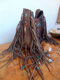 Native American inspired Handmade Leather Fringed Crossbody Bag.. Dark vintage brown Leather. Crossbody or Shoulder Bag depend your mood !! Beautiful Ethnic Handbag with Fringes and Beads. Painted with Native American Symbols-Desings- embroidered with nice colors! Both side of the Bag are Fringed and decoraded with beads-(you can ad your personal charms if you want). I enjoy every moment creating this exceptional Bag. Become better with hard use.Will take beautiful shades when aging. I wish that Bohemian Hand-stitched Bags, Bohemian Leather Shoulder Bag With Hand-stitched Details, Brown Shoulder Bag With Tassels For Festival, Bohemian Brown Hand-tooled Shoulder Bag, Handmade Leather Shoulder Bag For Festivals, Hippie Handmade Shoulder Bag For Festival, Handmade Hippie Shoulder Bag For Festival, Hippie Handmade Festival Shoulder Bag, Bohemian Hand-stitched Leather Bags